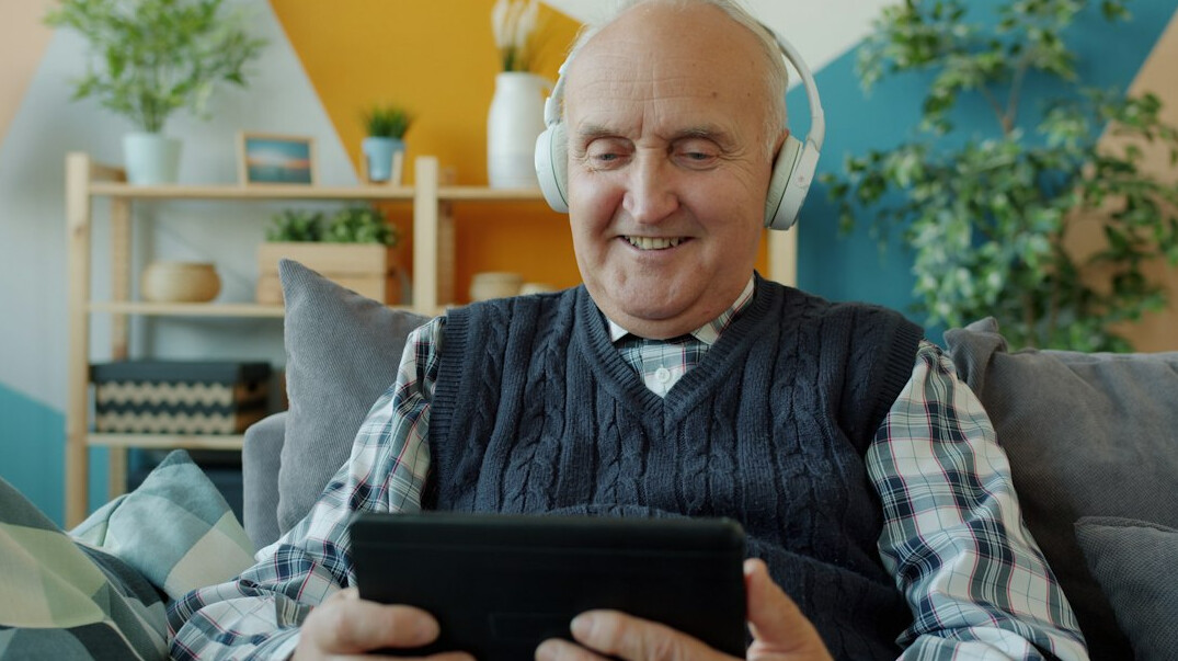 elderly couple reading newspaper