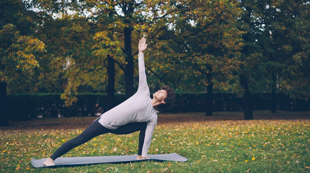 senior doing yoga in park