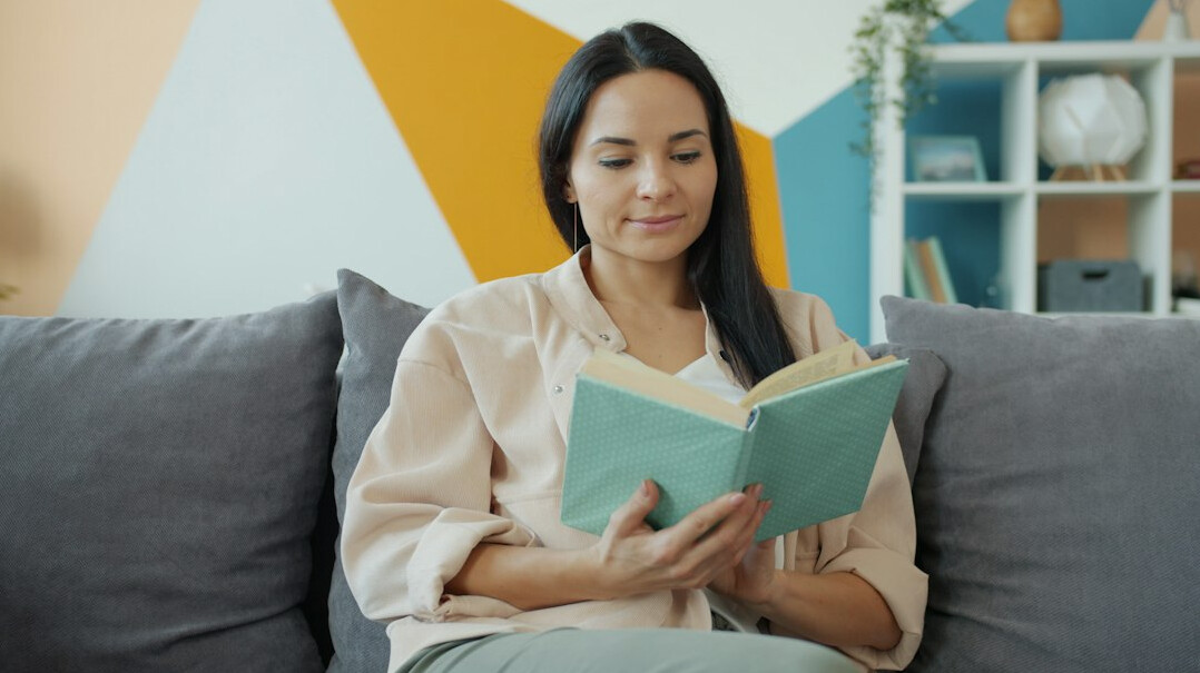 senior reading book at home