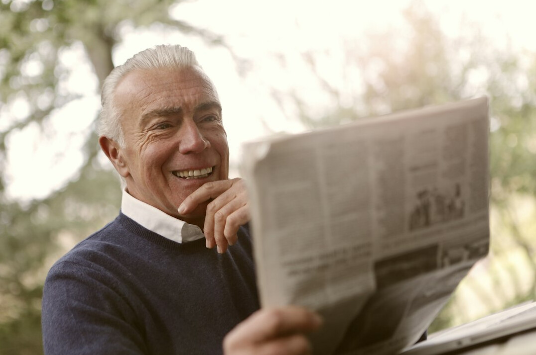 senior reading newspaper